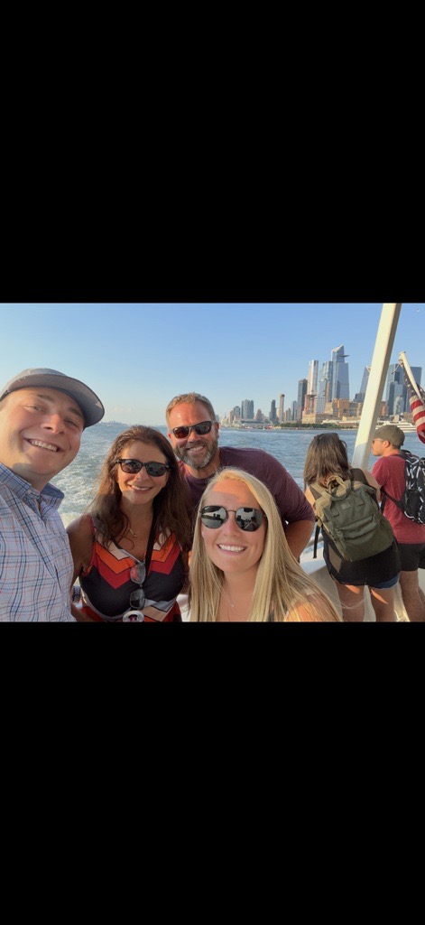 Mum, Eric, Caryn, and Ryan on a boat with the NYC skyline behind
